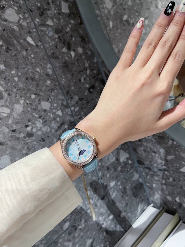 金白同价 欧米茄超霸月相系列 38Mm的精钢表壳搭配彩色数字色泽温柔雅致，呈现和谐的刚柔并济之美。佩戴起来简约清爽，突显优雅气质的同时也非常百搭，将超霸月相表的