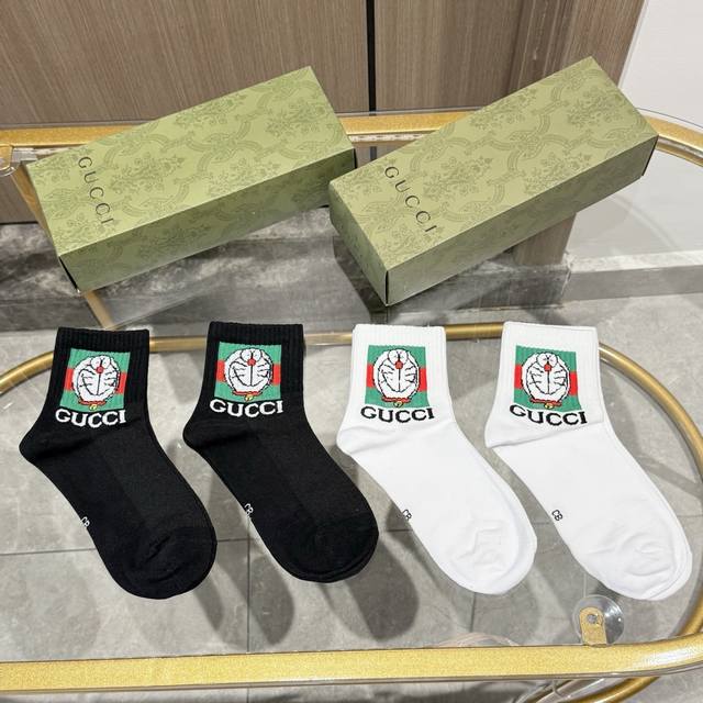 Package includes four pairs of Gucci mid-calf socks, a new style for men and wom