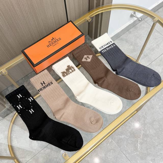 A box of five Hermer classic mid-calf cashmere socks, including packaging. Made