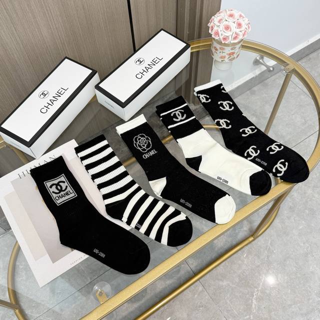 A box of five pairs of Chanel high-quality, super popular trending socks, featur