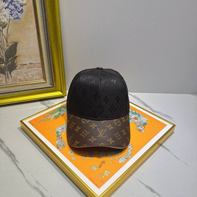A stunning classic Louis Vuitton baseball cap with a large floral print, meticul
