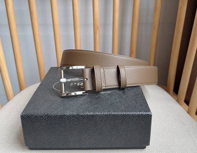 This is the latest Prada leather belt from the boutique. The tip is adorned wit